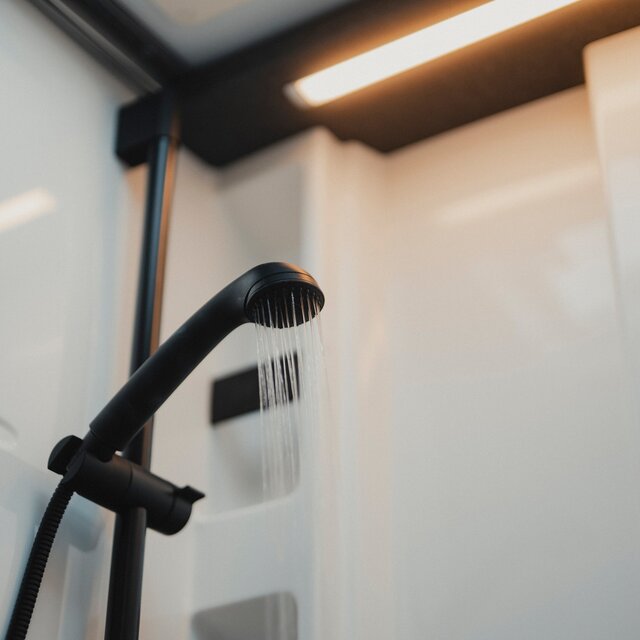Black shower fittings and matching shower head with running water
